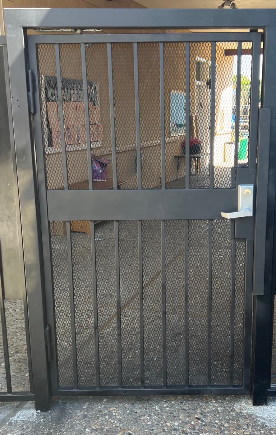 Gate with anti-reach mesh welded on and a lever lock installed