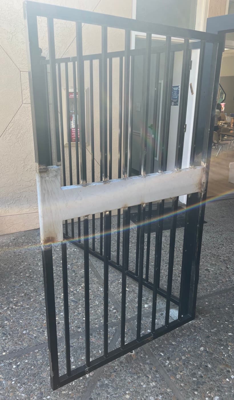 Steel plate welded across a gate to mount a lock