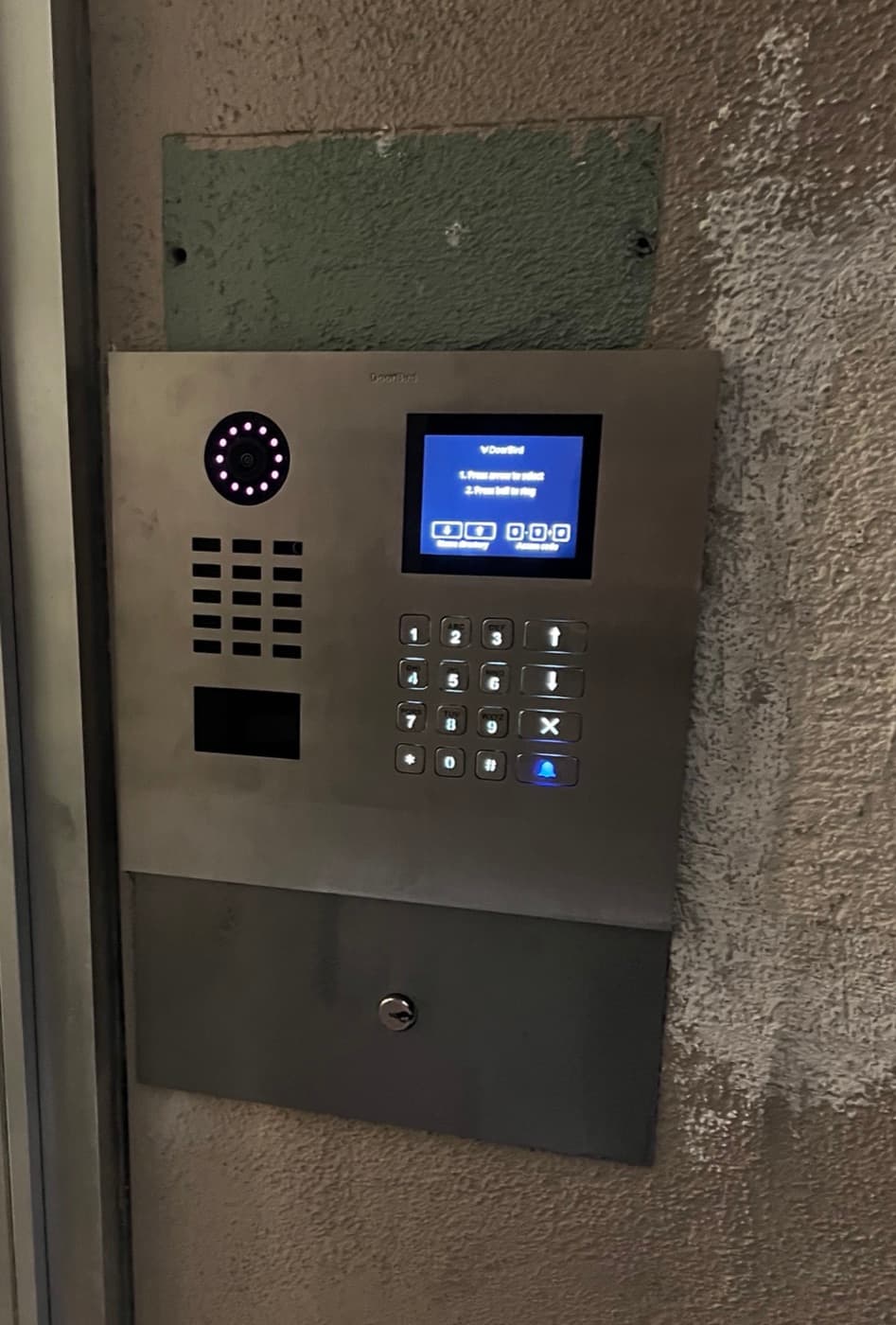 Building entry panel with a touchscreen tenant directory, keypad, and card reader