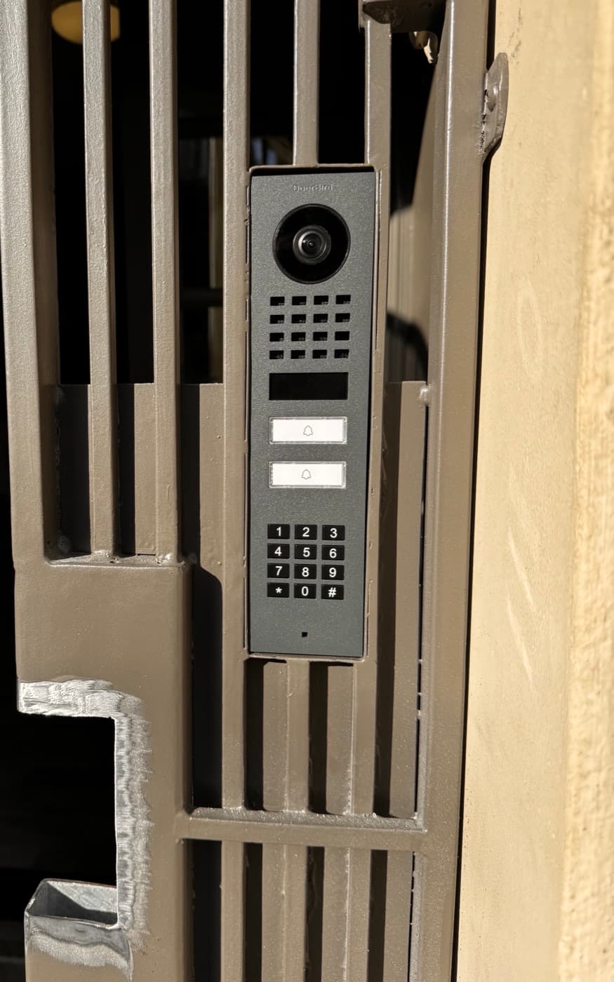 Video intercom with keypad built into a custom-cut steel gate frame