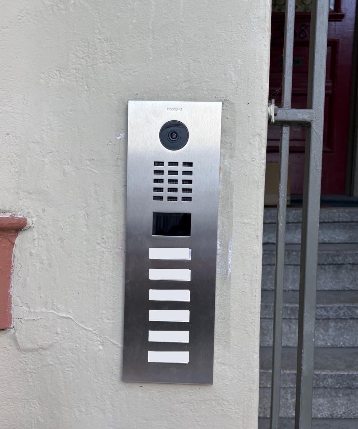 Multi-tenant video intercom with six call buttons at an apartment entrance